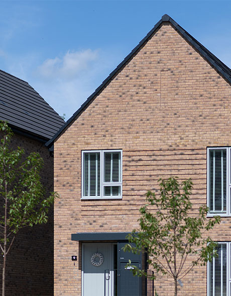 An external shot of Keld, a singular house with the sun shining on it.
