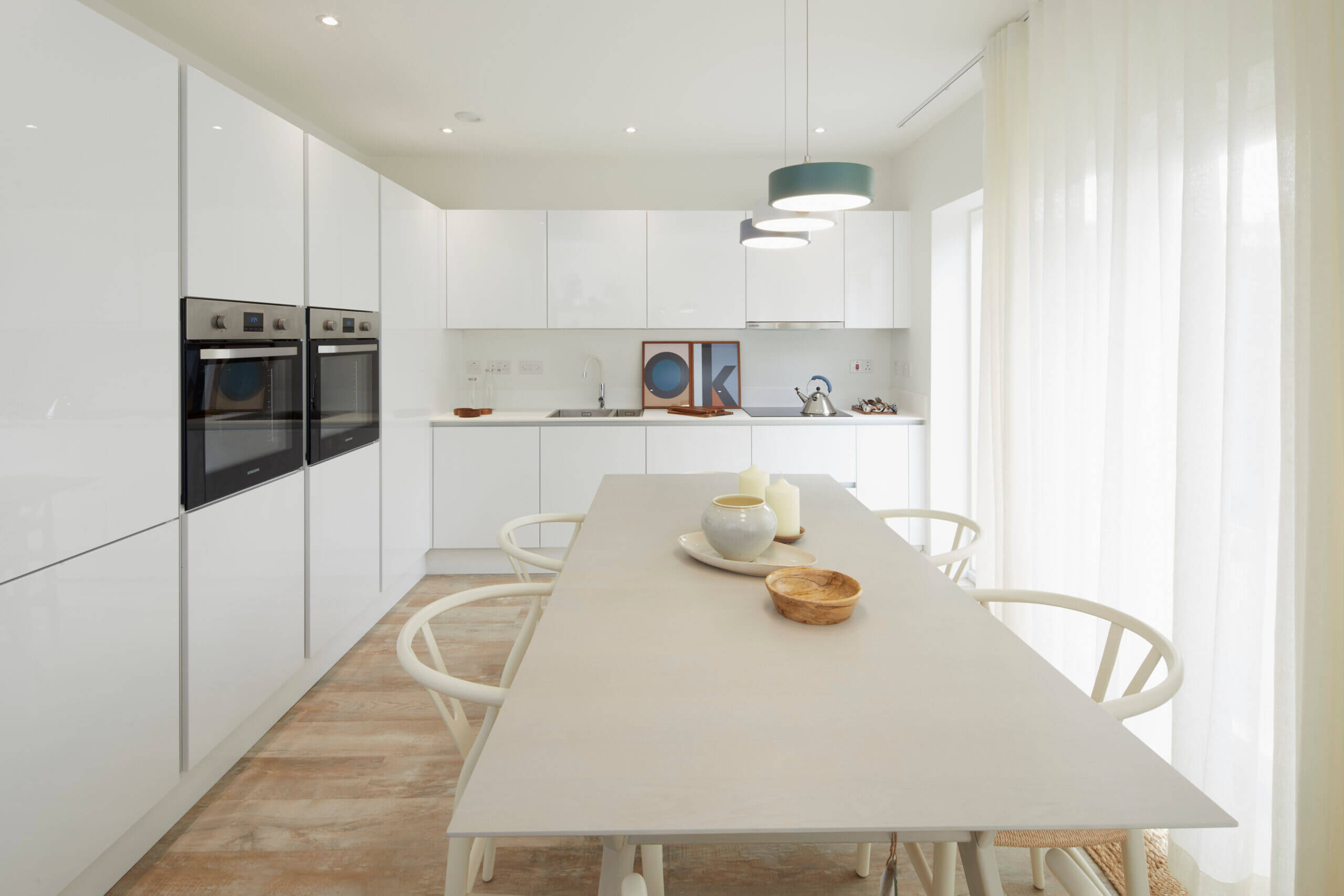 White kitchen cabinets with a large table